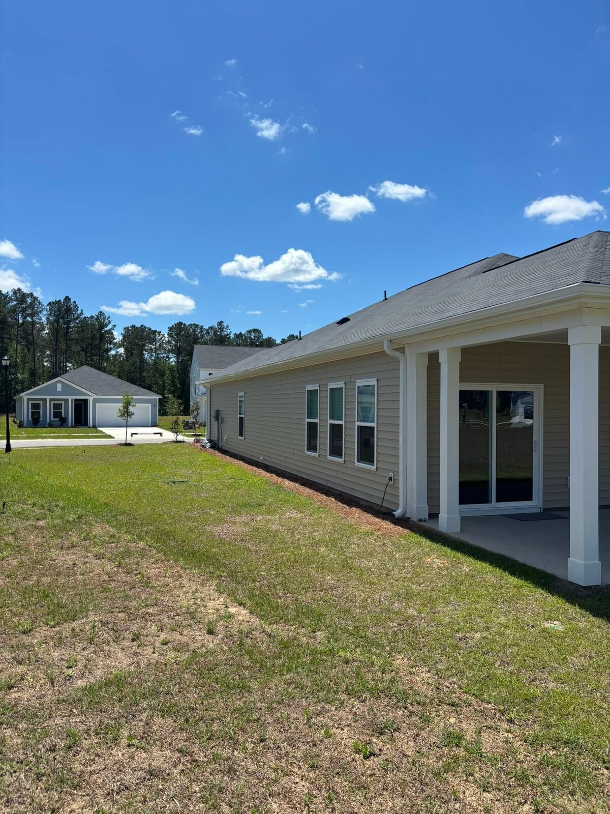 Long seamless gutter run along the side of a tan single-story home